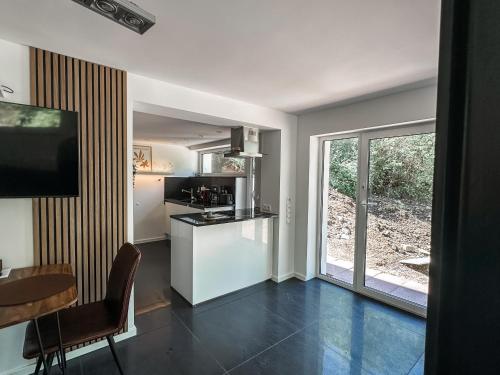 a kitchen and dining room with a table and a window at Geschäfts- und Monteurs Apartment 2 SZ in Königswinter