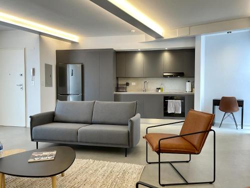 a living room with a couch and a table at Lesplanade By Wynwood House in Panama City