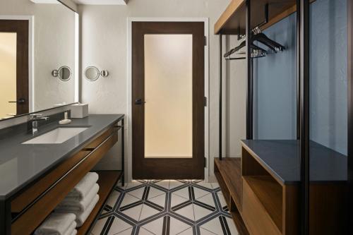 a bathroom with a sink and a mirror at Oshkosh Marriott Waterfront Hotel & Convention Center in Oshkosh