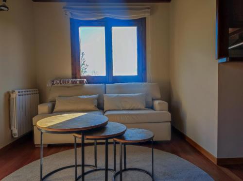 a living room with a couch and two tables at Ca la Rosa 2 in Llivia
