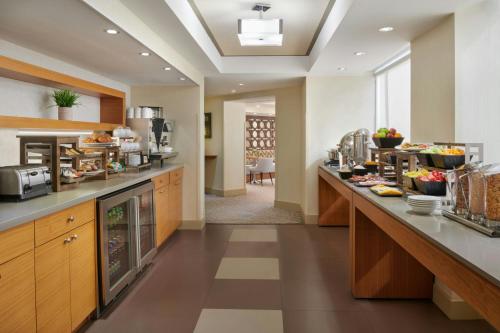 a kitchen with a long counter with food on it at Sheraton Parkway Toronto North Hotel & Suites in Richmond Hill