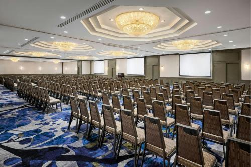 a large room with rows of chairs and a chandelier at Sheraton Hamilton Hotel in Hamilton