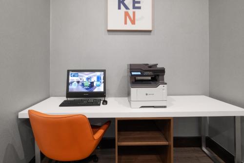 a desk with a computer and a printer on it at Holiday Inn Express & Suites Aiken by IHG in Aiken