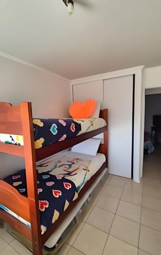 a bedroom with two bunk beds and an open door at Algarrobo Depto Vista Mar 3D2B, Pinares Canelillo in Algarrobo