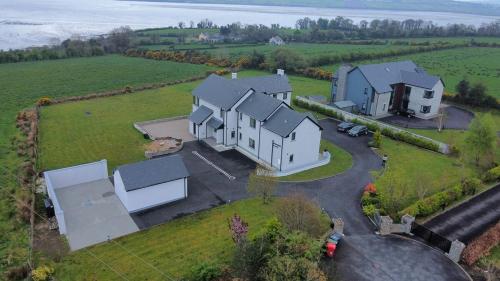 an aerial view of a large house in a field at Serene luxurious Retreat with Sea Views, Entire Home Letterkenny in Letterkenny
