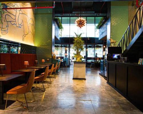 a restaurant with tables and chairs and a bar at alliance pearl Batumi in Batumi
