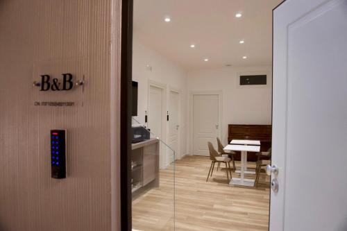 a door to a room with a table and a piano at Palazzo Simposio in Torremaggiore