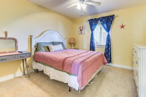 a bedroom with a bed and a dresser and a tv at Steps to Beach NMB Condo with Balcony and Pool Access in Myrtle Beach