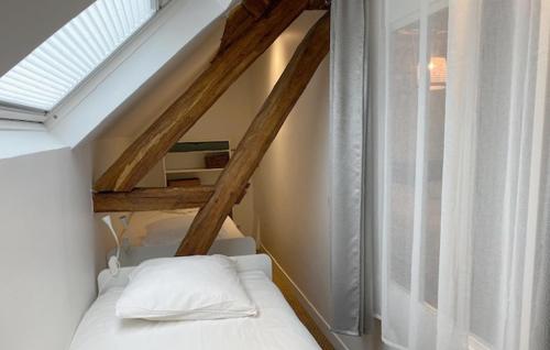 a small bedroom with a bed and a window at 4 Bedroom Amazing Home In Flacy in Lailly