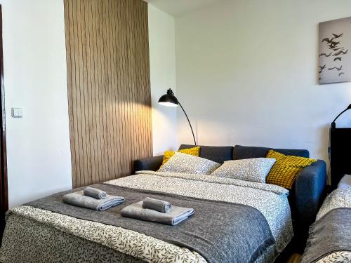 a bedroom with a bed with towels on it at ADM Historic Center Apartment - NETFLIX,Coffee, AC in Bratislava