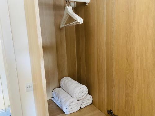a bunch of towels are sitting in a closet at Igloo Magnolia Room Stay I Breakfast I Free Parking in Leeds