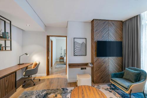 a living room with a desk and a chair at Four Points by Sheraton King Abdulaziz Road in Riyadh