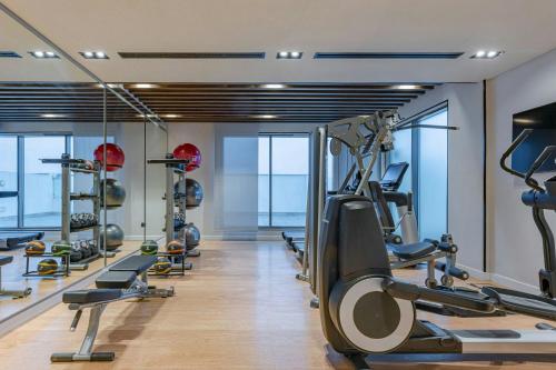 a gym with a row of treadmills and ellipticals at Four Points by Sheraton King Abdulaziz Road in Riyadh