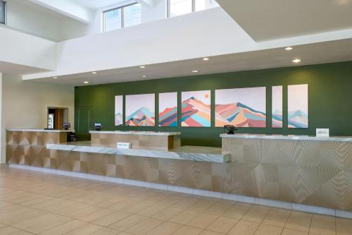 a lobby with a waiting area with mountains on the wall at Residence Inn Phoenix Desert View at Mayo Clinic in Phoenix