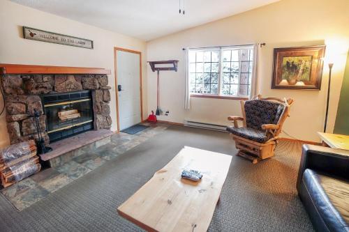 a living room with a fireplace and a couch at Timber Creek Chalets- 12 chalet in Estes Park