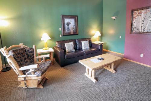 a living room with a couch and a coffee table at Timber Creek Chalets- 12 chalet in Estes Park