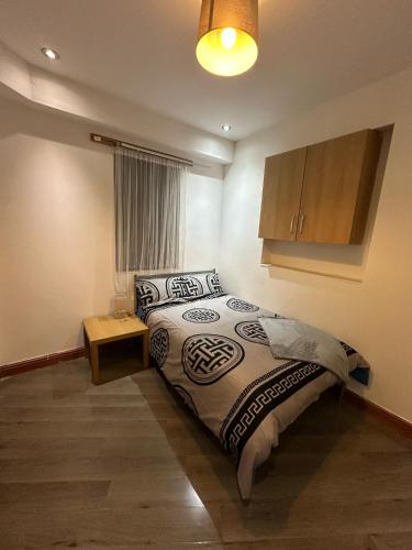 a bedroom with a bed and a table in it at Room 1 in south Yorkshire in Sheffield