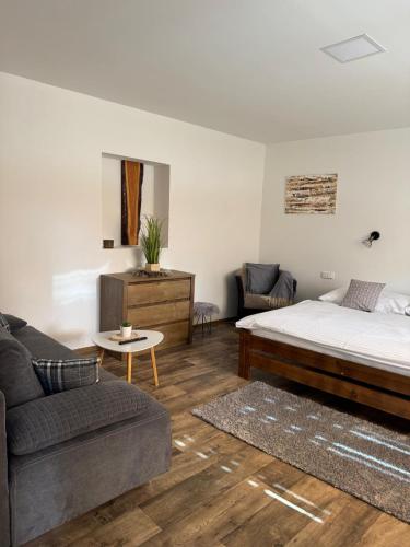 a living room with a bed and a couch at Ubytování 121 - Hlohovec in Hlohovec