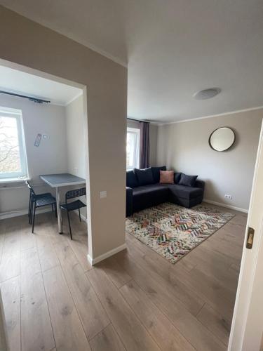 a living room with a couch and a table at V5 central in Valmiera