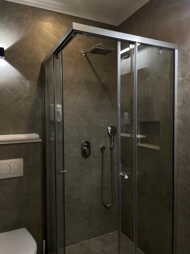a shower with a glass door in a bathroom at Vue Mer in Ulcinj