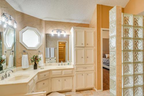 a bathroom with a large sink and a large mirror at 8 Mi to Texas Tech Home with Patio in Lubbock in Lubbock