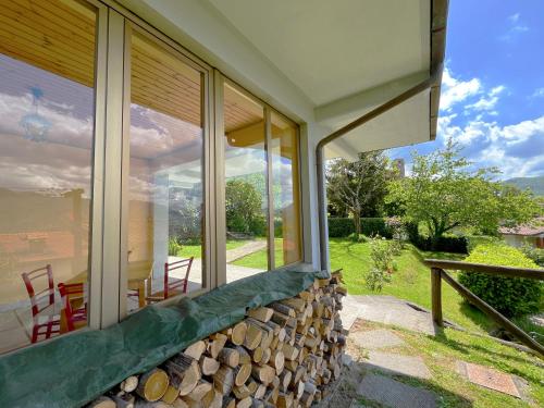 a glass house with a stone wall and a patio at Villa Martino in Piteglio