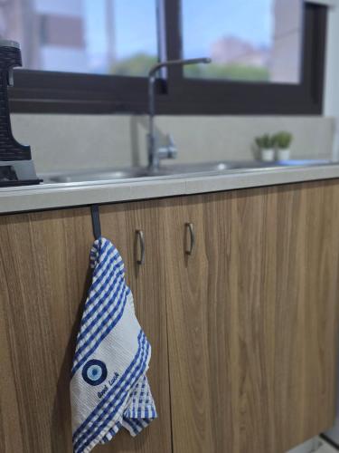 a towel is hanging from a kitchen cabinet at Epicurian Residence in Nicosia