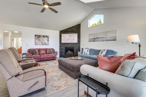a living room with two couches and a fireplace at Anacortes Home with Views of Puget Sound in Anacortes