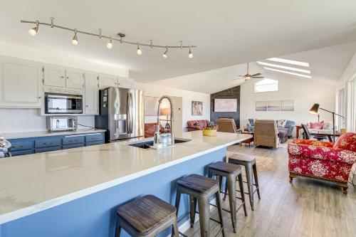a kitchen and living room with a bar and stools at Anacortes Home with Views of Puget Sound in Anacortes