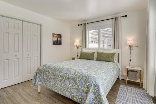 a white bedroom with a bed and a window at Anacortes Home with Views of Puget Sound in Anacortes