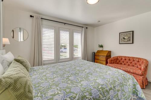 a bedroom with a bed and a chair and a window at Anacortes Home with Views of Puget Sound in Anacortes