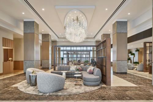 a lobby with a couch and chairs and a chandelier at The Westin Charlotte in Charlotte