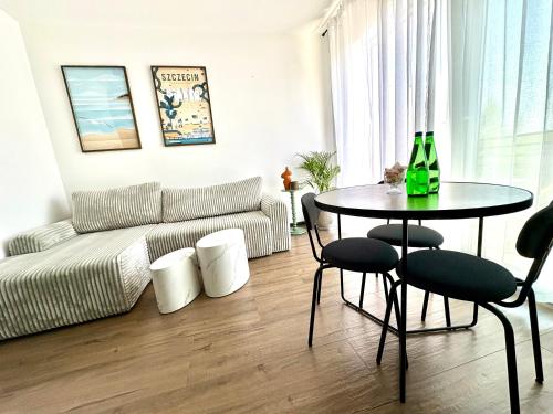 a living room with a table and a couch at Port ZS Wrzosowo in Dziwnówek