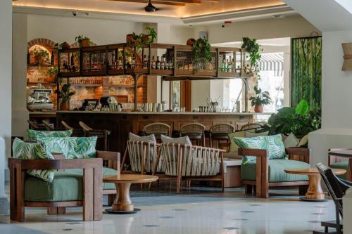 a restaurant with chairs and tables and a bar at The Buenaventura Golf & Beach Resort, Autograph Collection in Playa Blanca