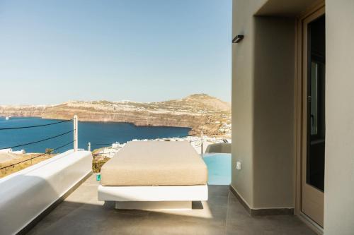 a balcony with a table and a view of the ocean at Black Diamond Suites in Akrotiri