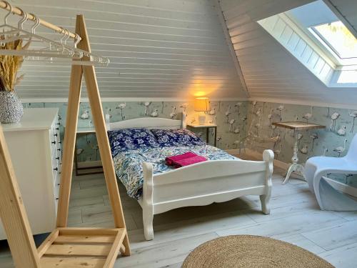 a bedroom with a white bed and a ladder at Tajemnicza Kraina in Wetlina