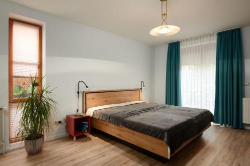 a bedroom with a large bed with green curtains at ToHuus in Laboe