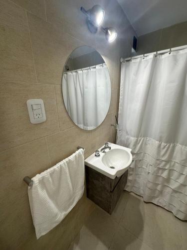 a bathroom with a sink and a mirror at Dpto Villa María - Excelente Estadía in Villa María