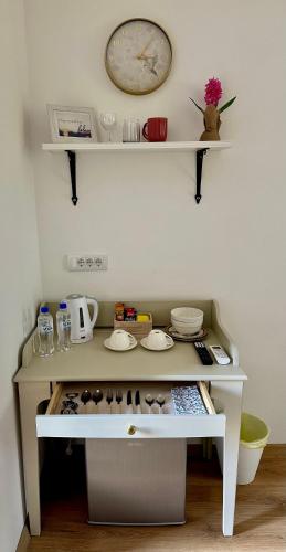 a white table with a clock on a wall at Kruna Palića in Palić