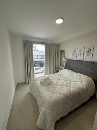 a bedroom with a bed with a stuffed animal on it at Dpto Villa María - Excelente Estadía in Villa María