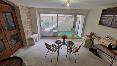 a living room with a table and chairs and a staircase at Epoca B&B in Bitetto
