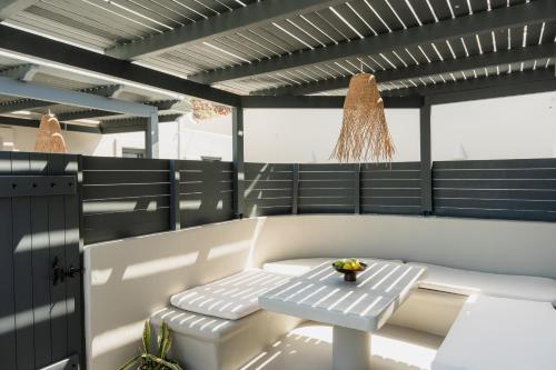 a bench on a boat with a table at Black Diamond Suites in Akrotiri