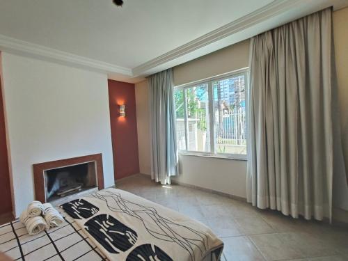 Hospedagem Central Curitiba - O seu lar longe de casaにあるベッド
