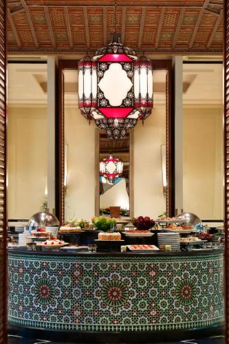 a buffet in a hotel with a table with food at Le Meridien Al Khobar in Al Khobar