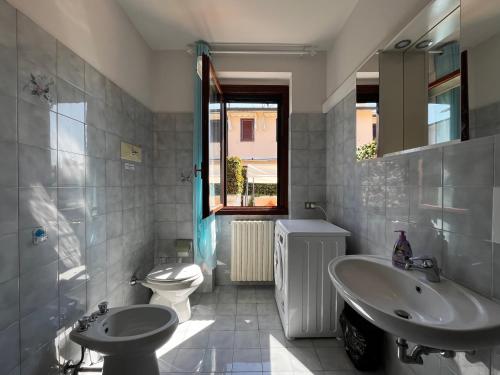 a bathroom with a sink and a toilet and a tub and a sink at Villa Grifone in Sirmione