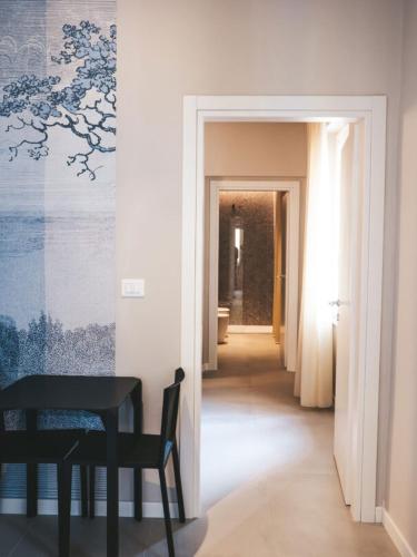 a dining room with a table and a hallway at Tre Monumenti Luxury Suites in Terni