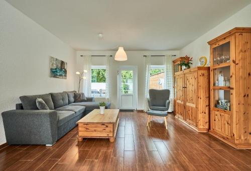 a living room with a couch and a coffee table at Ferienbungalow LEO in Petersdorf auf Fehmarn