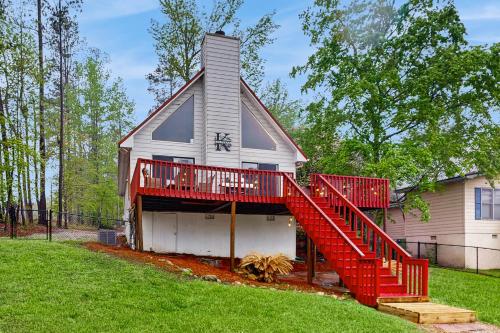 a house with a red staircase on the side of it at The Wonder of Woodslake in Eatonton