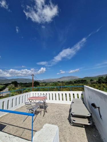 a patio with a table and chairs and a table at Iliana's Bungalow in Arménoi