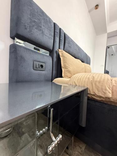 a bedroom with a bed and a table in it at Galactic&Ludmila Suite SPA in Braşov